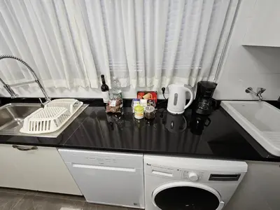 a kitchen counter with a sink and a dishwasher at Ilheus 1 in Funchal
