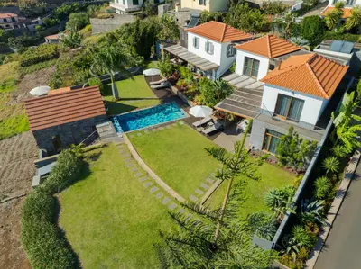an aerial view of a house with a swimming pool at Casas Da Vereda in Estreito da Calheta