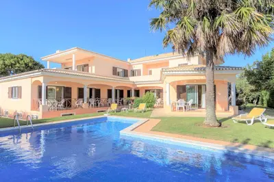 a large house with a swimming pool in front of it at Canavial I & II Apartamentos in Lagos
