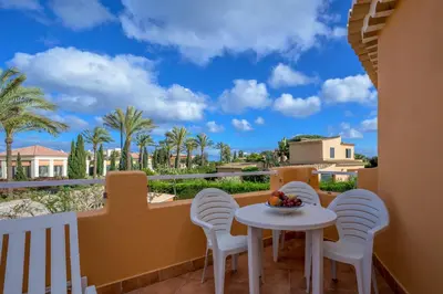 a balcony with a table and chairs and a view at Canavial I & II Apartamentos in Lagos