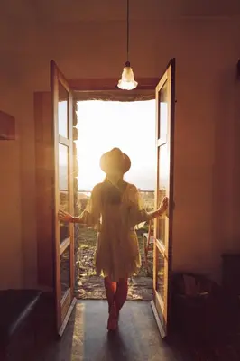 a woman in a yellow dress walking through a door at Casas da Levada in Ponta do Pargo