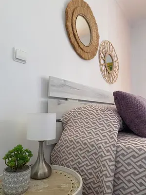 a bedroom with a bed and a mirror on the wall at Casa do Cavacas in Funchal