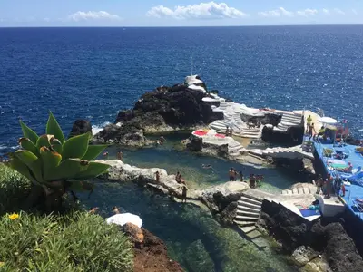 a group of people in a pool in the ocean at Casa do Cavacas in Funchal