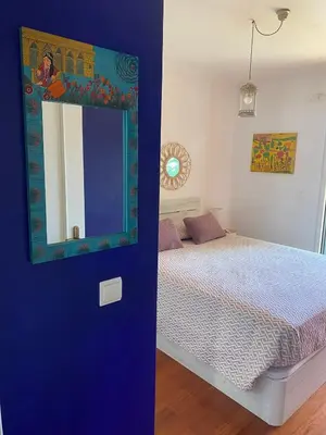 a bedroom with a bed and a mirror on a wall at Casa do Cavacas in Funchal