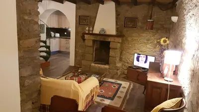 a living room with a stone fireplace and a couch at Casa da Camacha in Porto Santo