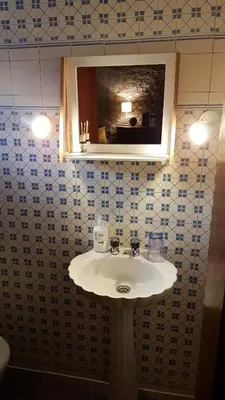 a bathroom with a sink and a mirror at Casa da Camacha in Porto Santo