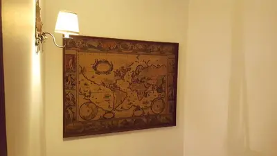 a tapestry hanging on a wall next to a lamp at Casa da Camacha in Porto Santo