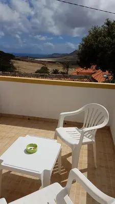 a white table and a white chair and a table at Casa da Camacha in Porto Santo