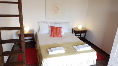a small room with a bed and a ladder at Casa da Camacha in Porto Santo