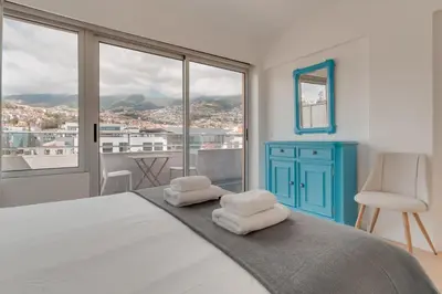 a bedroom with a bed with towels on it at Arriaga apartment in Funchal