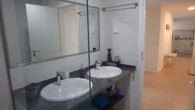 a bathroom with two sinks and a mirror at Arriaga apartment in Funchal
