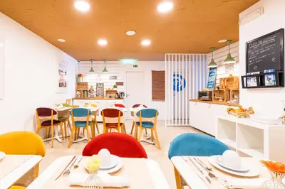 a restaurant with tables and chairs and a counter at Casa Azul Sagres - Rooms & Apartments in Sagres
