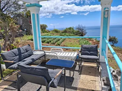a table with a vase of flowers on top of a boat at Casa d'Alegria Madeira Island in Ribeira Brava