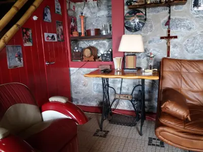 a small room with a table and a cross on the wall at Casa d'Alegria Madeira Island in Ribeira Brava