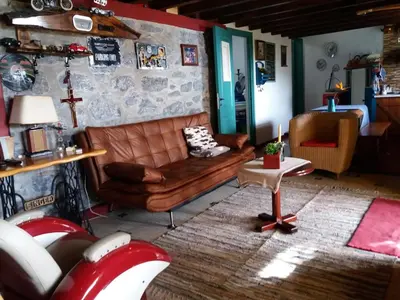 a living room with a couch and a table at Casa d'Alegria Madeira Island in Ribeira Brava