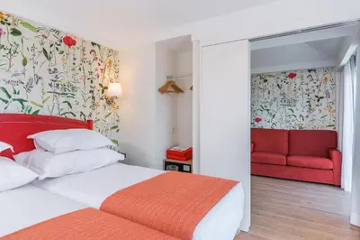 a hotel room with a bed and a television at Pestana Quinta do Arco Nature & Rose Garden Hotel in Arco de São Jorge