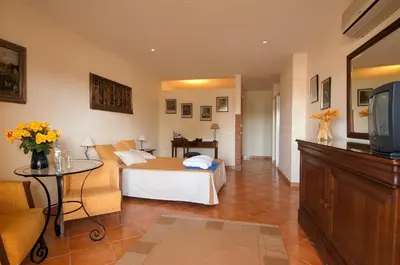 a hotel room with a bed and a tv at Luzmar Villas in Luz