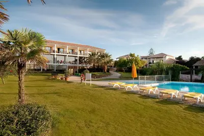 a resort with a swimming pool and a hotel at Luzmar Villas in Luz