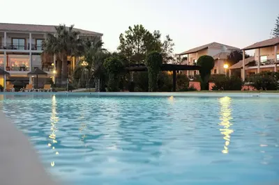 a large swimming pool in front of a building at Luzmar Villas in Luz