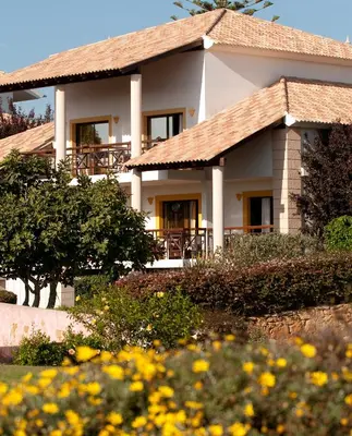 a house with a garden in front of it at Luzmar Villas in Luz