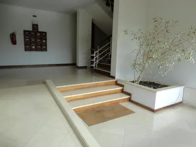 a staircase with a potted tree in a room at Apartamento Raio de Sol in Caniço