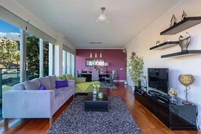 a living room with a couch and a tv at Monumental Residence apartment with pool by HR Madeira in Funchal