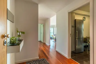 a kitchen with a stainless steel refrigerator in a room at Monumental Residence apartment with pool by HR Madeira in Funchal
