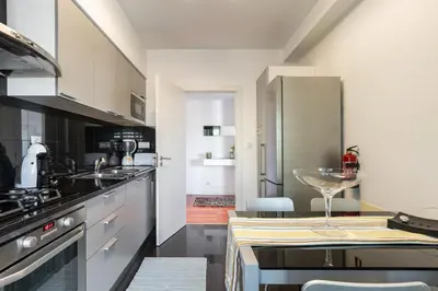 a kitchen with a wine glass sitting on a table at Monumental Residence apartment with pool by HR Madeira in Funchal