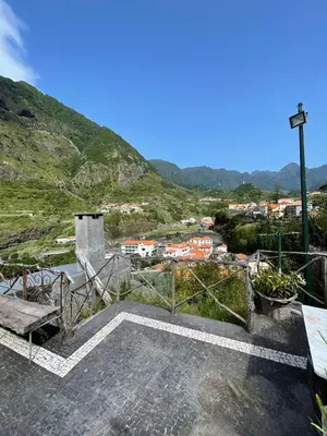 a room with a bench and a view of a mountain at A Casa Estrelícia-Dourada Garcês in São Vicente