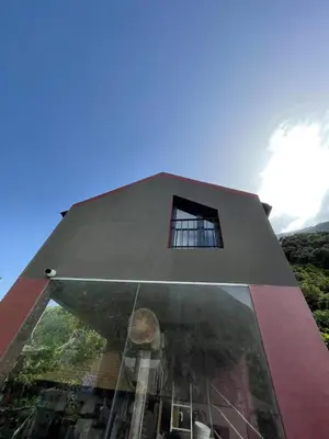 a building with a window on the side of it at A Casa Estrelícia-Dourada Garcês in São Vicente