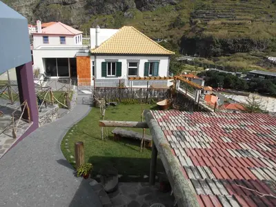 a view of a house from a balcony at A Casa Estrelícia-Dourada Garcês in São Vicente