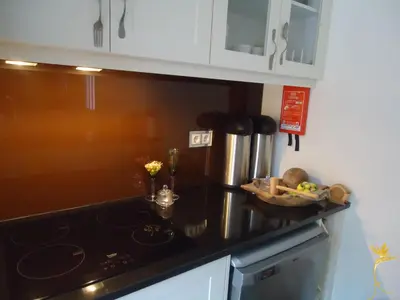a kitchen with a stove and a counter top at A Casa Estrelícia-Dourada Garcês in São Vicente