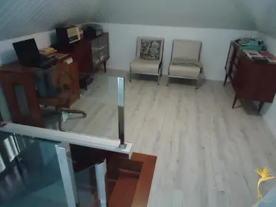 a living room with a desk and a chair and a desk and a desk at A Casa Estrelícia-Dourada Garcês in São Vicente