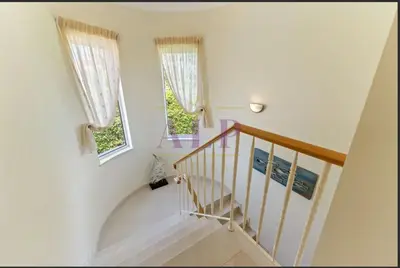 a staircase with white walls and two windows at 4 bed 4 bathroom villa Quinta da Boavista in Lagos