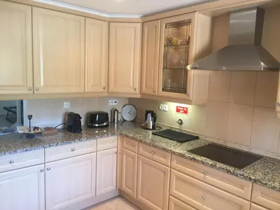 a kitchen with white cabinets and granite counter tops at 4 bed 4 bathroom villa Quinta da Boavista in Lagos