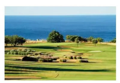 a view of a golf course with the ocean in the background at 4 bed 4 bathroom villa Quinta da Boavista in Lagos