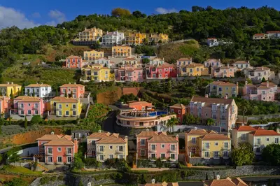 a village on a hill with houses at Palheiro Village Resort in Funchal