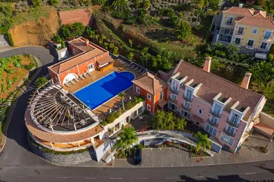 an aerial view of a house with a swimming pool at Palheiro Village Resort in Funchal
