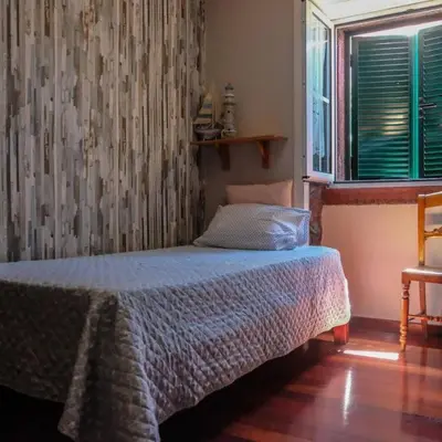 a bedroom with a bed and a window at Casa da Guida in Paul do Mar