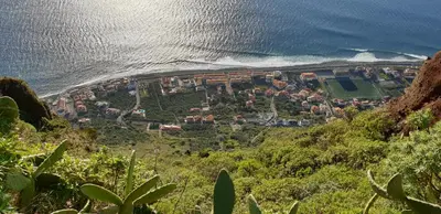 an aerial view of a village on a hill next to the ocean at Casa da Guida in Paul do Mar