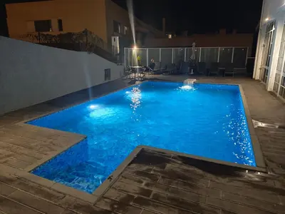 a large blue swimming pool at night at Residencial Melba in Funchal