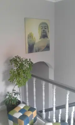 a picture of a statue on the wall next to a staircase at Residencial Melba in Funchal