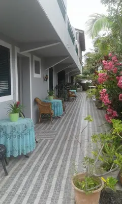 a patio with two tables and chairs and flowers at Residencial Melba in Funchal