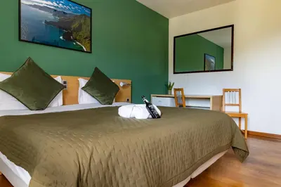 a bedroom with a bed with a stuffed animal on it at Casa Os Manos in Santana