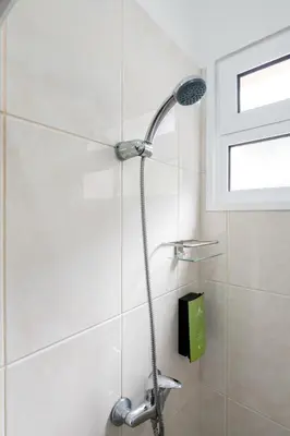 a shower with a shower head in a bathroom at Casa Os Manos in Santana