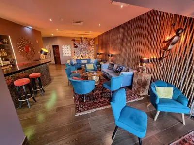 a lobby with blue chairs and a bar at Boutique Hotel Vivenda Miranda in Lagos
