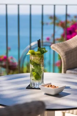 a glass of water and a plate of food on a table at Boutique Hotel Vivenda Miranda in Lagos
