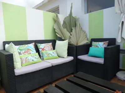 two wicker chairs with colorful pillows on a patio at Barreirinha Funcho House in Funchal