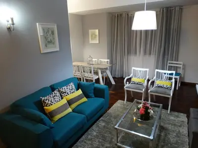 a living room with a blue couch and chairs at Barreirinha Funcho House in Funchal
