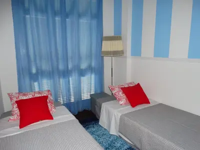 a bedroom with two beds with red pillows at Barreirinha Funcho House in Funchal